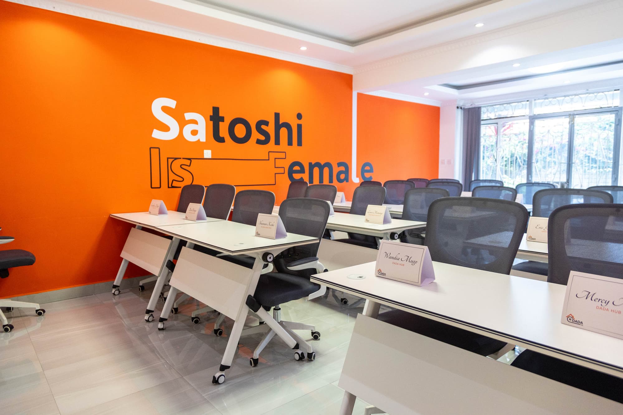 Dada Hub's training room in Nairobi, with a 'Satoshi is Female' wall installation